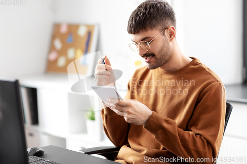 Image of man in glasses with notebook working at office