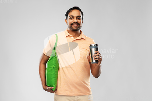 Image of man with food in bag and tumbler or thermo cup