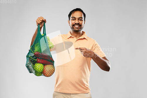 Image of happy indian man with food in reusable net tote