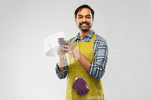 Image of indian male gardener or farmer with smartphone