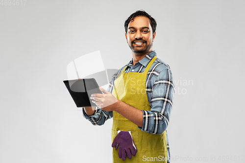 Image of indian male gardener or farmer with tablet pc