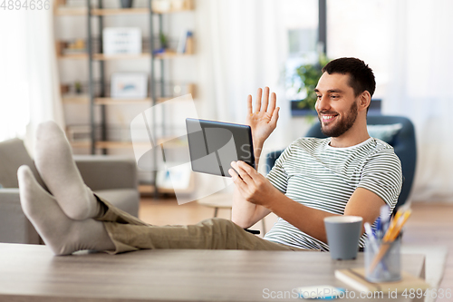 Image of man with tablet pc having video call at home