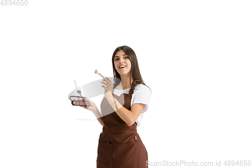 Image of Young woman, visagiste with cosmetics isolated on white studio background