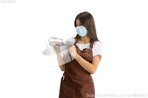 Image of Young woman, visagiste with cosmetics isolated on white studio background