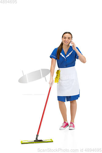 Image of Portrait of female made, cleaning worker in white and blue uniform isolated over white background