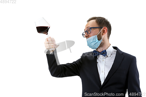 Image of Portrait of male sommelier in suit isolated over white background