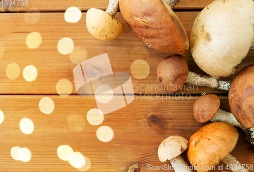 Image of brown cap boletus mushrooms on wooden background