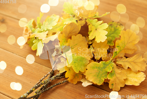 Image of oak leaves in autumn colors on wooden table