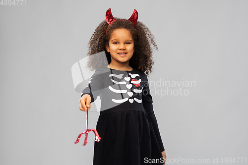 Image of girl with trident and devil's horns on halloween