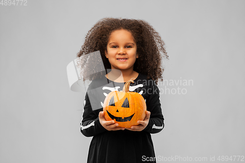 Image of girl in black halloween dress with jack-o-lantern