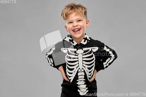 Image of boy in black halloween costume with skeleton bones