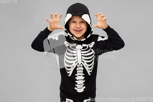 Image of boy in halloween costume of skeleton making faces