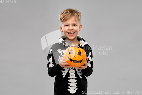 Image of happy boy in halloween costume with jack-o-lantern