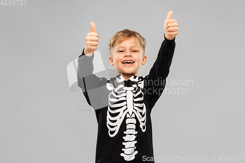 Image of boy in black halloween costume showing thumbs up