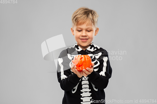 Image of happy boy in halloween costume with jack-o-lantern