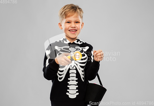 Image of happy with candies and flashlight on halloween