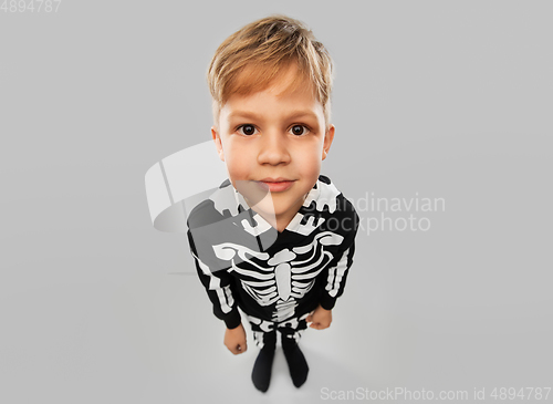 Image of boy in black halloween costume with skeleton bones