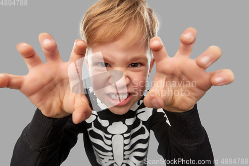 Image of boy in halloween costume of skeleton making faces