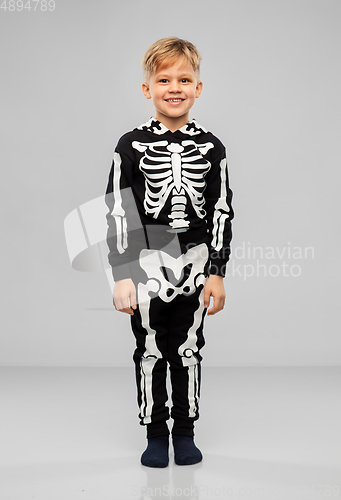 Image of boy in black halloween costume with skeleton bones