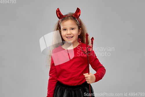 Image of girl with trident and devil's horns on halloween