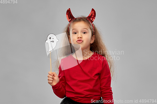 Image of girl in halloween costume with ghost party prop