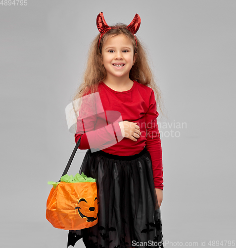 Image of girl with horns trick-or-treating on halloween