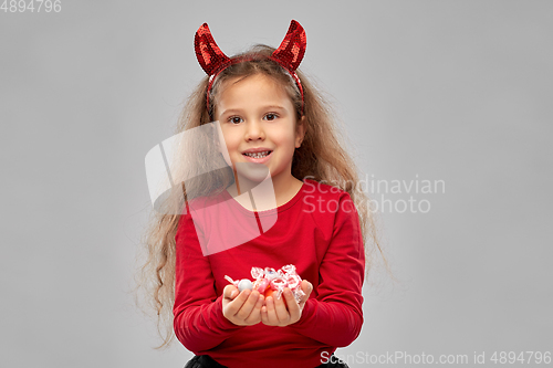 Image of girl with horns trick-or-treating on halloween