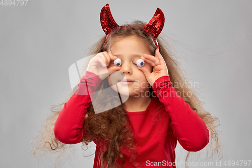 Image of girl in halloween costume and devil's horns