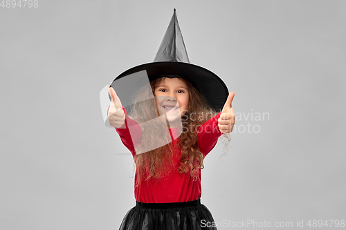 Image of happy girl in black witch hat on halloween