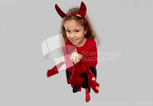 Image of girl with trident and devil's horns on halloween