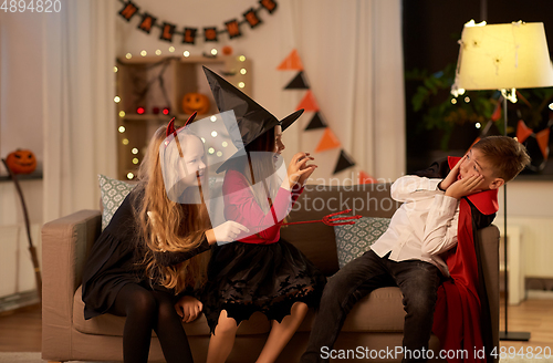 Image of kids in halloween costumes playing at home