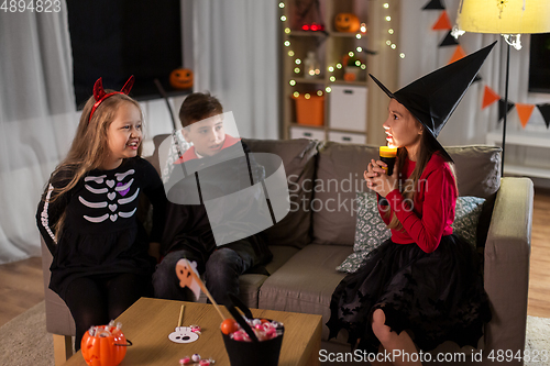 Image of kids in halloween costumes playing at home