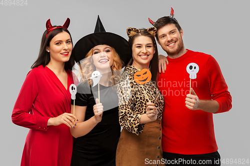 Image of friends in halloween costumes with party props