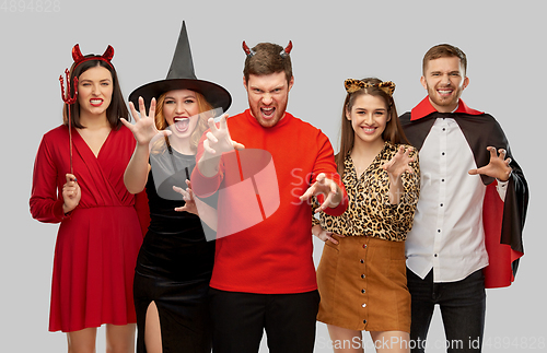 Image of friends in halloween costumes scaring