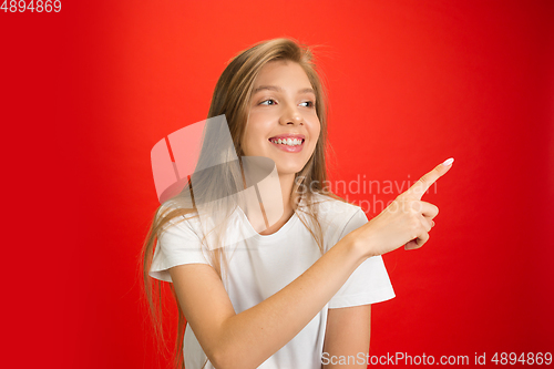 Image of Portrait of young caucasian woman with bright emotions on bright red studio background