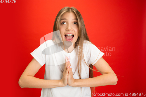 Image of Portrait of young caucasian woman with bright emotions on bright red studio background