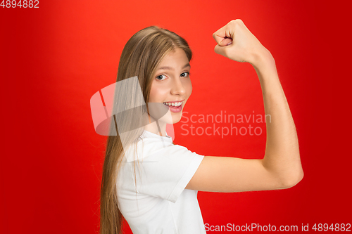 Image of Portrait of young caucasian woman with bright emotions on bright red studio background