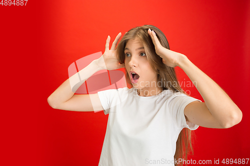 Image of Portrait of young caucasian woman with bright emotions on bright red studio background