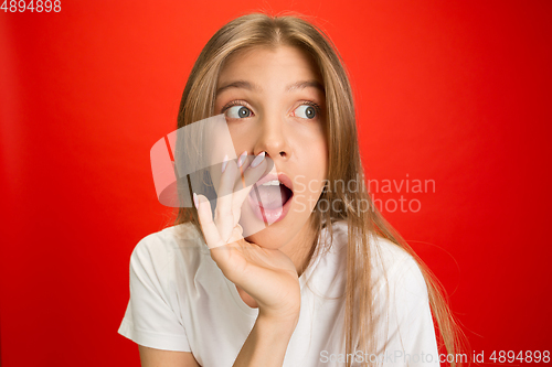 Image of Portrait of young caucasian woman with bright emotions on bright red studio background