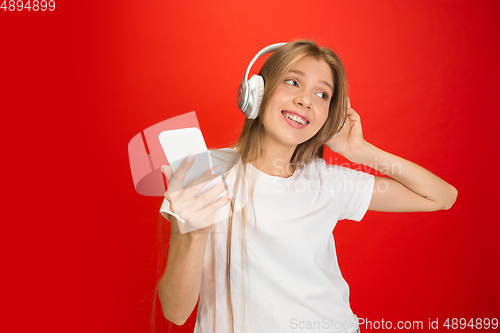 Image of Portrait of young caucasian woman with bright emotions on bright red studio background