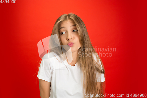 Image of Portrait of young caucasian woman with bright emotions on bright red studio background