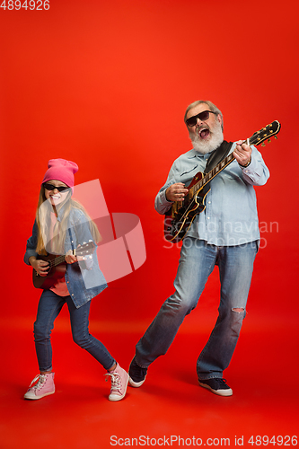 Image of Senior man, grandfather having fun and spending time together with girl, granddaughter. Joyful elderly lifestyle concept