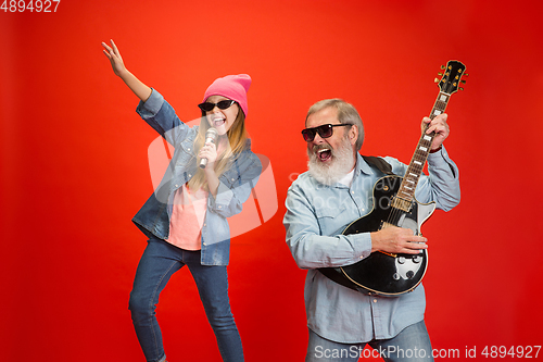 Image of Senior man, grandfather having fun and spending time together with girl, granddaughter. Joyful elderly lifestyle concept