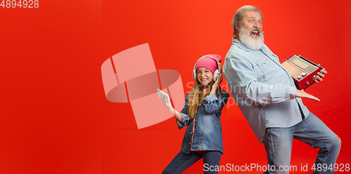Image of Senior man, grandfather having fun and spending time together with girl, granddaughter. Joyful elderly lifestyle concept