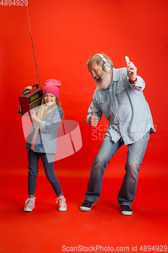 Image of Senior man, grandfather having fun and spending time together with girl, granddaughter. Joyful elderly lifestyle concept