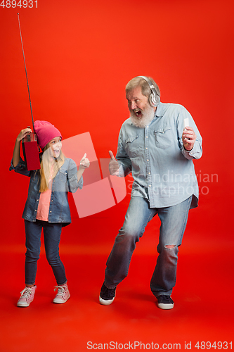 Image of Senior man, grandfather having fun and spending time together with girl, granddaughter. Joyful elderly lifestyle concept