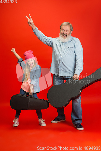 Image of Senior man, grandfather having fun and spending time together with girl, granddaughter. Joyful elderly lifestyle concept