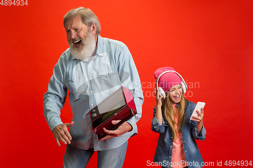 Image of Senior man, grandfather having fun and spending time together with girl, granddaughter. Joyful elderly lifestyle concept