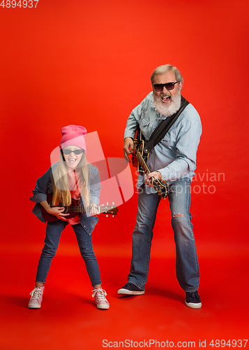 Image of Senior man, grandfather having fun and spending time together with girl, granddaughter. Joyful elderly lifestyle concept