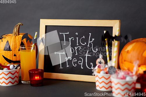 Image of pumpkins, candies and halloween decorations